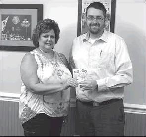 Stephanie Rouse, left, won two tickets for the Ohio State-Michigan State game from Yoss Law Office. Pictured presenting the tickets is Todd Abbott.