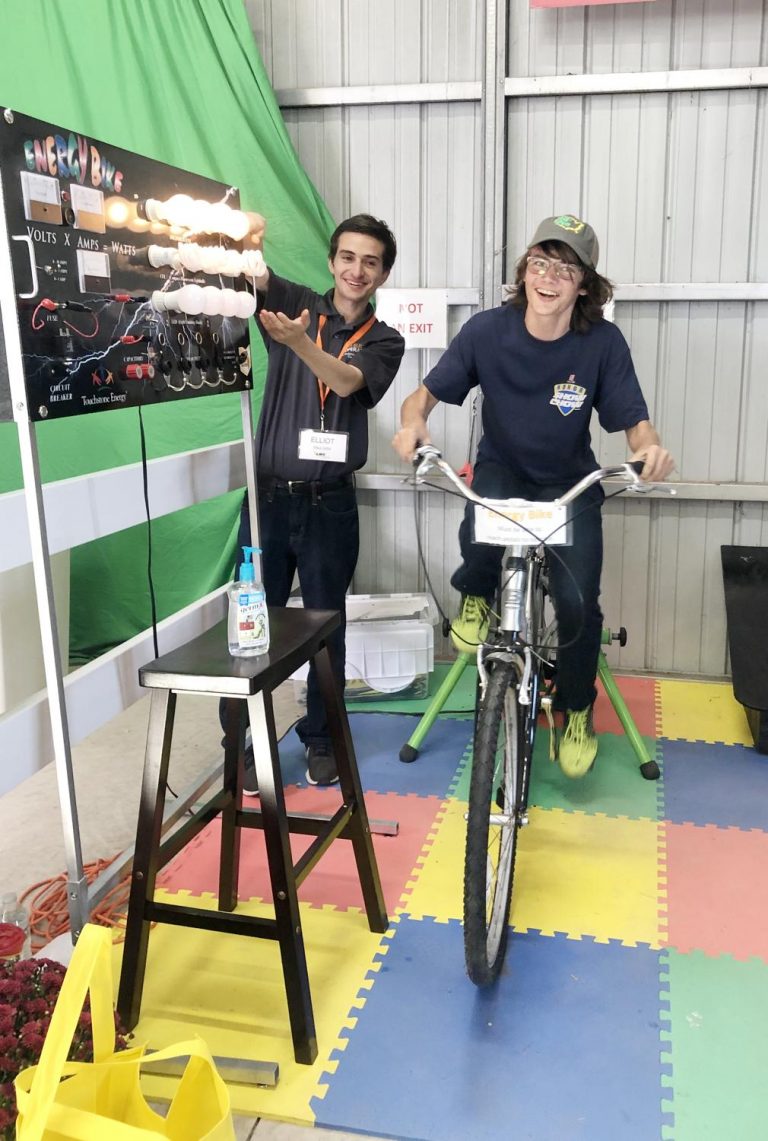Monroe Central High School freshman Connell McBurney challenges himself to see how many rows of light bulbs he can light as he pedals the energy-generating bike Wednesday, Sept. 18 at the Farm Science Review.